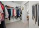 Walk-in closet with shelving and hanging space, with the Primary bedroom visible in the background at 10627 Hatteras Dr, Tampa, FL 33615