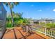 Relaxing waterfront deck with outdoor seating and scenic views of the canal and boats at 10627 Hatteras Dr, Tampa, FL 33615