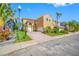 Exterior of a two-story home featuring a manicured lawn, paver driveway, and mature landscaping at 10627 Hatteras Dr, Tampa, FL 33615