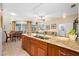 Open-concept kitchen with granite countertops and hardwood cabinetry with nearby seating and stainless appliances at 10627 Hatteras Dr, Tampa, FL 33615