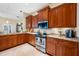 Spacious kitchen with wood cabinets, granite countertops, and stainless steel appliances at 10627 Hatteras Dr, Tampa, FL 33615