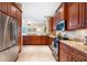 Updated kitchen featuring wood cabinets, granite countertops, and stainless steel appliances at 10627 Hatteras Dr, Tampa, FL 33615