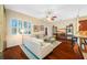 Open living room with hardwood floors, comfortable seating, and natural light at 10627 Hatteras Dr, Tampa, FL 33615