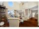 Well-lit living room featuring hardwood floors and access to outdoor screened lanai at 10627 Hatteras Dr, Tampa, FL 33615
