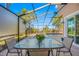 Cozy patio with table and chairs, perfect for enjoying the view of the pool and the yard at 10627 Hatteras Dr, Tampa, FL 33615