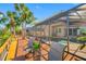 Outdoor living with a poolside deck, lush palm trees, and screened enclosure for added comfort at 10627 Hatteras Dr, Tampa, FL 33615