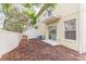 Cozy townhouse backyard featuring a sliding door and a small patio area, perfect for outdoor relaxation at 10906 Kensington Park Ave, Riverview, FL 33578