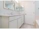 Stylish bathroom with a marble countertop vanity, white cabinets, framed mirror, and a clean, modern design at 10906 Kensington Park Ave, Riverview, FL 33578