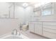Elegant bathroom showcasing a double mirror, vanity with marble countertop, and white cabinetry at 10906 Kensington Park Ave, Riverview, FL 33578