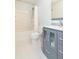 Bathroom featuring tub with shower, toilet, and blue vanity with sink at 10906 Kensington Park Ave, Riverview, FL 33578