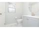 Clean and modern bathroom with a vanity and large round mirror at 10906 Kensington Park Ave, Riverview, FL 33578