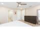 Spacious bedroom showing ensuite bathroom, a ceiling fan, neutral colors, and natural light at 10906 Kensington Park Ave, Riverview, FL 33578