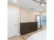 Serene bedroom with natural light, neutral decor, and ample storage in a sleek, modern dresser at 10906 Kensington Park Ave, Riverview, FL 33578