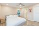 Light-filled bedroom features a plush bed, ample natural light, and ensuite bathroom access for added convenience at 10906 Kensington Park Ave, Riverview, FL 33578