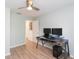 Bedroom with a dark wooden desk, two monitors and neutral walls at 10906 Kensington Park Ave, Riverview, FL 33578