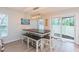Stylish dining area with a modern table, bench seating, and sliding doors to outdoor space at 10906 Kensington Park Ave, Riverview, FL 33578