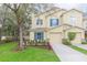 Charming two-story townhome with a well-manicured lawn and attached one-car garage at 10906 Kensington Park Ave, Riverview, FL 33578