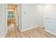 Bright hallway features wood-look flooring and neutral paint, creating a welcoming and modern transition space at 10906 Kensington Park Ave, Riverview, FL 33578