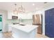 Modern kitchen with stainless steel appliances, stylish lighting, and a functional island sink at 10906 Kensington Park Ave, Riverview, FL 33578