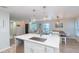 Bright kitchen with large island connecting to the living and dining area at 10906 Kensington Park Ave, Riverview, FL 33578