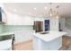 Modern kitchen with white cabinets, stainless steel appliances, and a stylish island with bar seating at 10906 Kensington Park Ave, Riverview, FL 33578