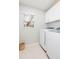 Bright laundry room featuring a washer and dryer, storage cabinets, and a window at 10906 Kensington Park Ave, Riverview, FL 33578