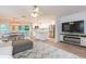 Open-concept living space featuring modern decor, natural light, and seamless flow into the kitchen at 10906 Kensington Park Ave, Riverview, FL 33578