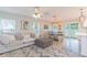 Bright and airy living room showcasing modern decor, a comfortable seating area, and a dining space at 10906 Kensington Park Ave, Riverview, FL 33578