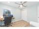 Bright office featuring ceiling fan, desk, and a large closet at 10906 Kensington Park Ave, Riverview, FL 33578