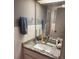 Bathroom featuring white tile, granite countertop, framed mirror and a large sink at 1111 Bayshore Blvd # B-10, Clearwater, FL 33759