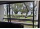 Balcony view overlooking lush landscaping, trees, and a body of water at 1111 Bayshore Blvd # B-10, Clearwater, FL 33759