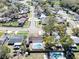 Aerial view of neighborhood homes with mature trees, swimming pools and lake in the distance at 11206 Mondale Ave, Seffner, FL 33584