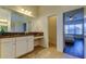 Bathroom featuring dual sinks with granite counters and vanity with make up area at 11257 Egeria Dr, Odessa, FL 33556