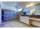 Bathroom with dual sinks, granite counters, and tile and glass shower stall at 11257 Egeria Dr, Odessa, FL 33556