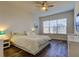 Bright bedroom with large window, ceiling fan, and crisp white comforter at 11257 Egeria Dr, Odessa, FL 33556