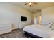 Bright bedroom with large window, ceiling fan, flat screen television and white dresser at 11257 Egeria Dr, Odessa, FL 33556