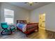 Comfortable bedroom with hardwood floors, natural light, and a relaxing rocking chair next to the window at 11257 Egeria Dr, Odessa, FL 33556