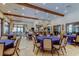 Community clubhouse featuring tables with blue tablecloths for seating, lots of lighting, and travertine floors at 11257 Egeria Dr, Odessa, FL 33556