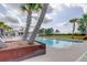 Tranquil community pool surrounded by palm trees, offering a relaxing and picturesque setting at 11257 Egeria Dr, Odessa, FL 33556