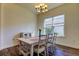 Bright dining area featuring hardwood floors, a classic chandelier, and natural light at 11257 Egeria Dr, Odessa, FL 33556