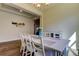 Dining room with wood floors, a vase of tulips and view of living space at 11257 Egeria Dr, Odessa, FL 33556