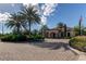 Beautiful clubhouse exterior with lush landscaping, palm trees, and a circular driveway at 11257 Egeria Dr, Odessa, FL 33556