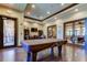 Well lit game room features a pool table, seating area, and exterior access at 11257 Egeria Dr, Odessa, FL 33556