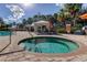 Inviting hot tub with clear blue water, surrounded by palm trees, cabanas, and comfortable seating at 11257 Egeria Dr, Odessa, FL 33556