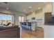 Modern kitchen with an island, barstool seating, stainless steel appliances, and sleek white cabinets at 11257 Egeria Dr, Odessa, FL 33556