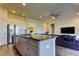 An open floor plan allows for a kitchen island with lots of cabinets and a view of the living room at 11257 Egeria Dr, Odessa, FL 33556