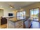 An open floor plan allows for a kitchen island with lots of cabinets and a view of the living room and back yard at 11257 Egeria Dr, Odessa, FL 33556