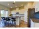 Stylish kitchen with island seating, granite countertops, stainless steel appliances, and hardwood floors at 11257 Egeria Dr, Odessa, FL 33556