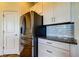 Features modern stainless steel appliances, white cabinetry, granite counters, and a subway tile backsplash at 11257 Egeria Dr, Odessa, FL 33556
