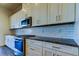 This kitchen features stainless steel appliances, granite counters and white cabinets at 11257 Egeria Dr, Odessa, FL 33556